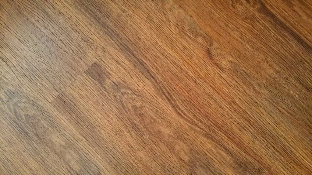 Detailed image of rustic wooden flooring with visible wood grain texture.